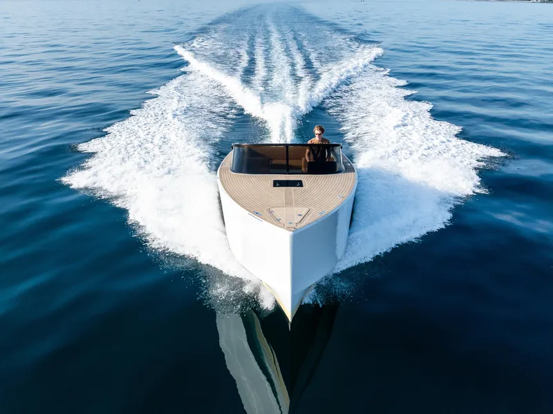Slide: The Image of VanDutch 32 yacht cruising on open water, 2023 model, sleek design, leaving a wake. - 8