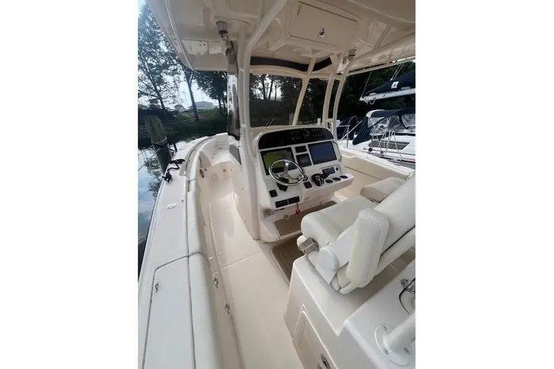 Slide: The Image of 2023 Grady-White Canyon 306 boat interior with helm and seating area. - 13