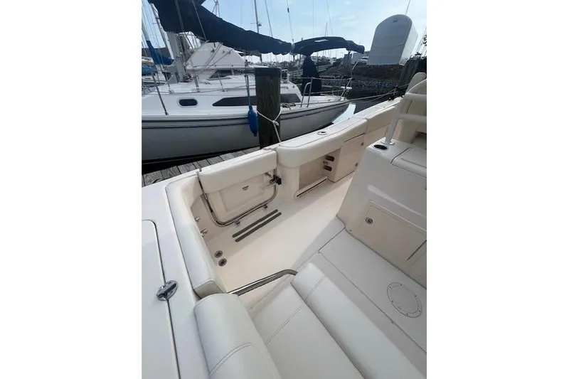 Slide: The Image of 2023 Grady-White Canyon 306 boat interior, featuring sleek seating and storage compartments. - 18