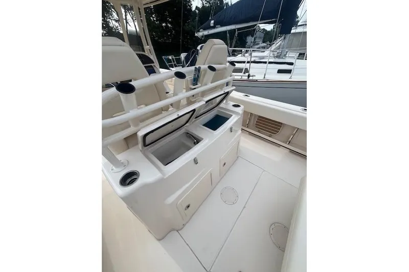 Slide: The Image of 2023 Grady-White Canyon 306 boat interior with storage compartments and rod holders. - 20