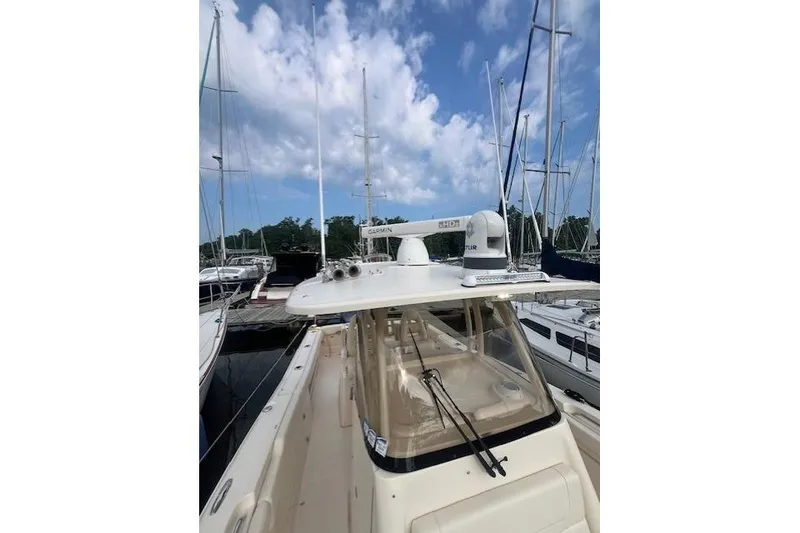 Slide: The Image of 2023 Grady-White Canyon 306 boat docked, featuring advanced navigation equipment. - 24