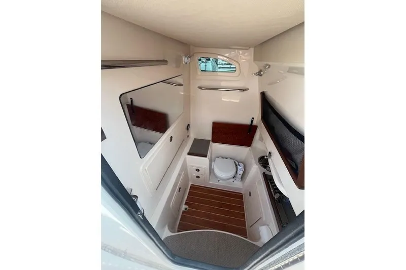 Slide: The Image of 2023 Grady-White Canyon 306 boat interior with compact bathroom amenities. - 26