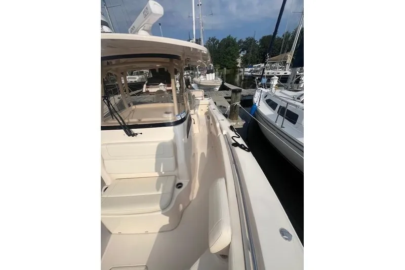 Slide: The Image of 2023 Grady-White Canyon 306 boat docked at marina, side view. - 5