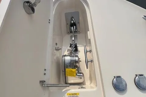 Slide: The Image of 2023 Grady-White Canyon 306 boat anchor compartment with winch and hardware. - 8