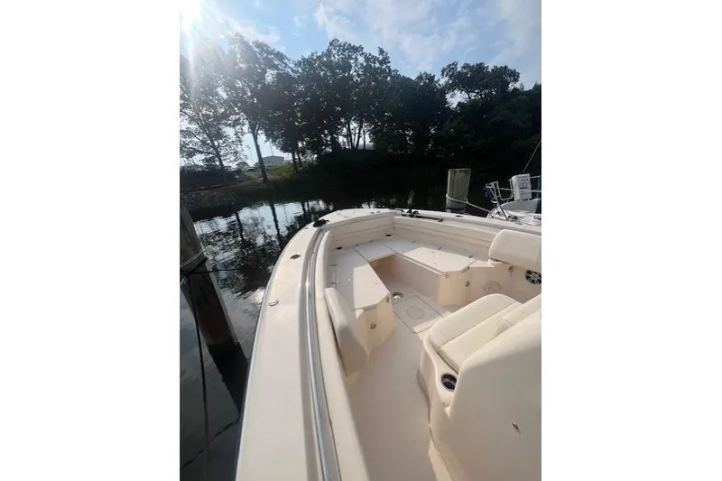 Slide: The Image of 2023 Grady-White Canyon 306 boat docked by a serene waterfront. - 9