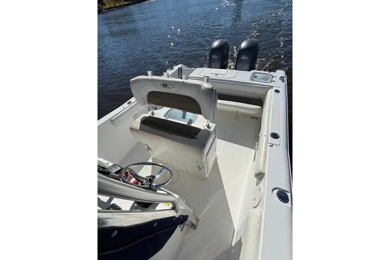 Slide: The Image of 2011 Sea Hunt Gamefish 25 boat interior with dual engines on a sunny day. - 12