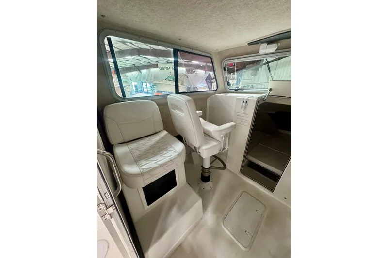 Slide: The Image of 2026 Parker 2520 XLD Sport Cabin interior with seating and helm, showcasing modern design. - 10