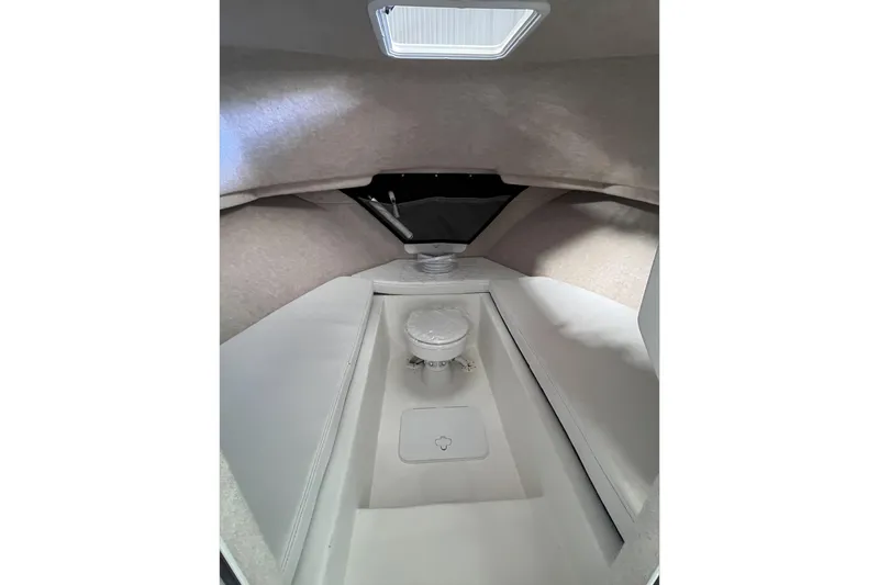 Slide: The Image of Interior of 2026 Parker 2520 XLD Sport Cabin, featuring a compact marine toilet. - 12