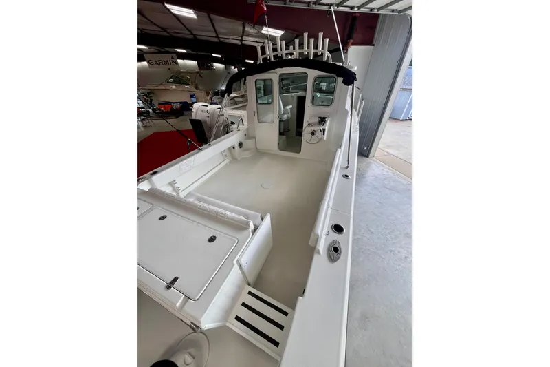 Slide: The Image of 2026 Parker 2520 XLD Sport Cabin boat interior, featuring spacious deck and modern design. - 5
