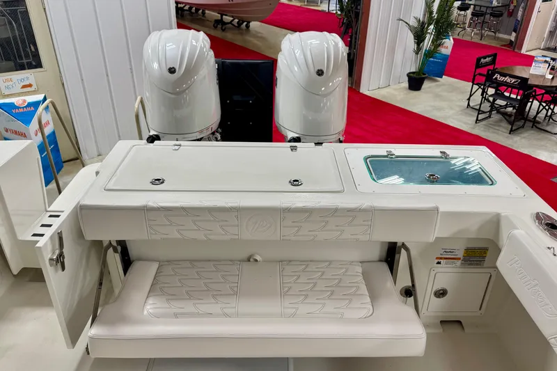 Slide: The Image of 2026 Parker 2520 XLD Sport Cabin boat interior with dual engines and seating. - 6