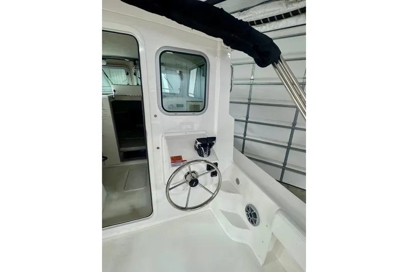 Slide: The Image of 2026 Parker 2520 XLD Sport Cabin interior with steering wheel and cabin door. - 7
