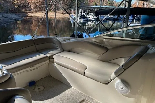 Slide: The Image of Interior of 2002 Sea Ray 240 Sundeck boat with beige seating and waterfront view. - 16