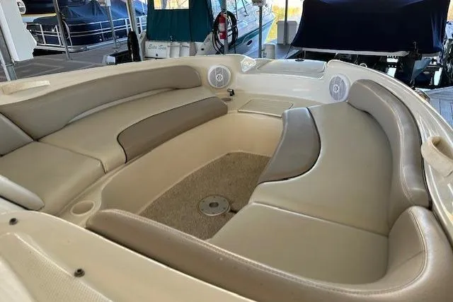 Slide: The Image of Interior seating of 2002 Sea Ray 240 Sundeck boat, featuring beige and gray upholstery. - 17