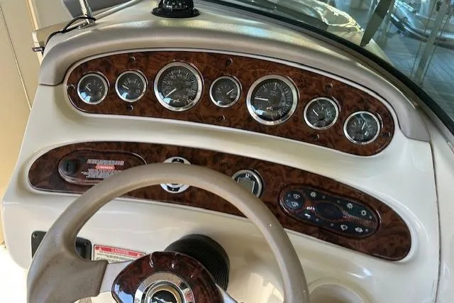 Slide: The Image of Dashboard of 2002 Sea Ray 240 Sundeck boat with gauges and steering wheel. - 18