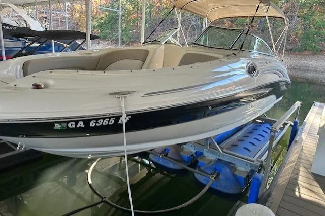 Slide: The Image of 2002 Sea Ray 240 Sundeck boat on lift, docked in marina. - 8