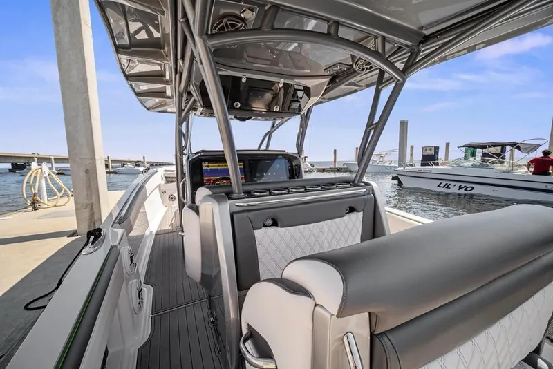 Slide: The Image of 2021 Nor-Tech 390 Sport Center Console boat interior at marina dock. - 16