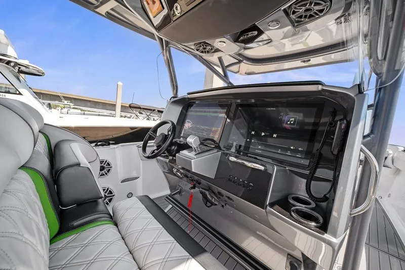 Slide: The Image of 2021 Nor-Tech 390 Sport Center Console interior with modern dashboard and luxurious seating. - 17