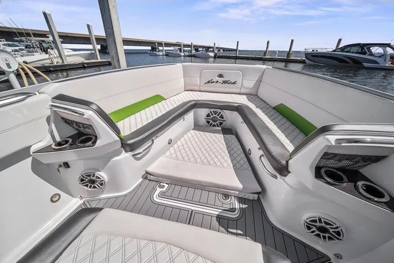 Slide: The Image of 2021 Nor-Tech 390 Sport Center Console boat interior with luxurious seating and cup holders. - 23