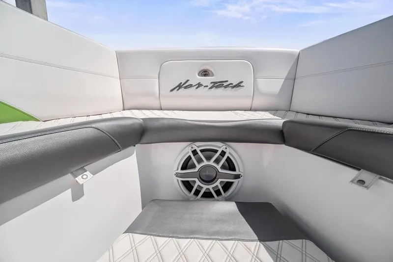 Slide: The Image of 2021 Nor-Tech 390 Sport Center Console interior with speaker and cushioned seating. - 24