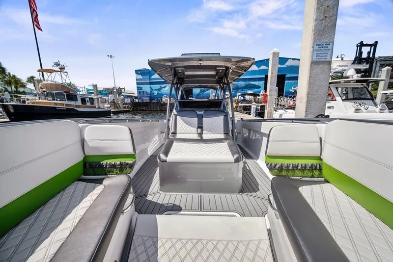 Slide: The Image of 2021 Nor-Tech 390 Sport Center Console boat with stylish seating and modern design at a marina. - 25