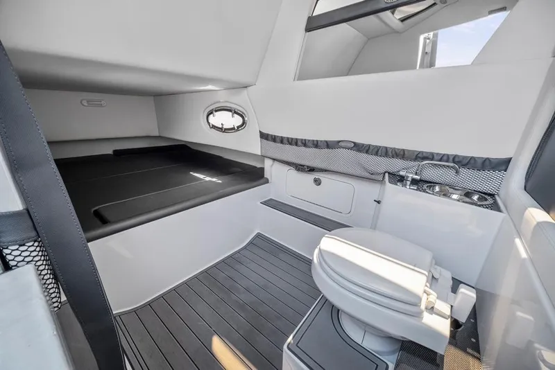 Slide: The Image of 2021 Nor-Tech 390 Sport Center Console cabin with bed, toilet, and sink. - 32