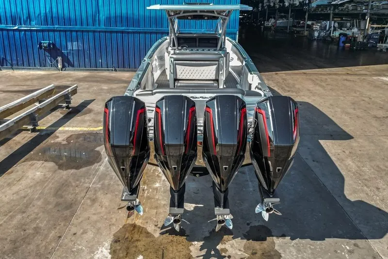 Slide: The Image of 2021 Nor-Tech 390 Sport Center Console with four powerful outboard engines. - 36