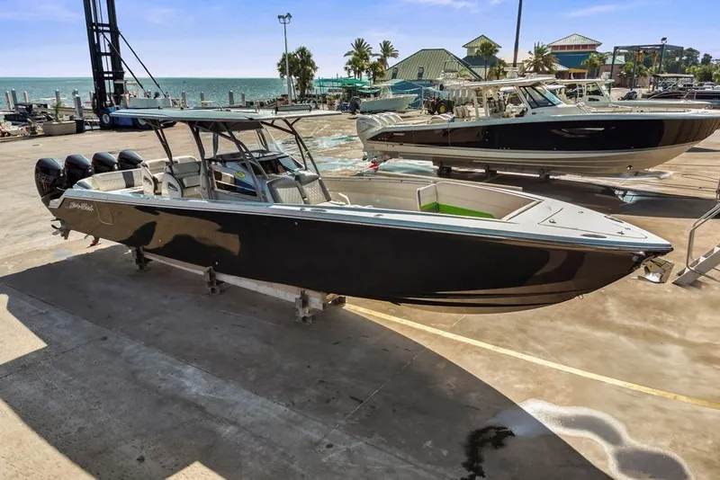 Slide: The Image of 2021 Nor-Tech 390 Sport Center Console boat docked near the ocean. - 39
