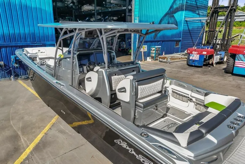 Slide: The Image of 2021 Nor-Tech 390 Sport Center Console boat docked, showcasing sleek design and modern features. - 44