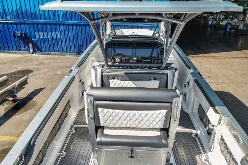 Slide: The Image of 2021 Nor-Tech 390 Sport Center Console boat interior with modern seating and dashboard. - 46
