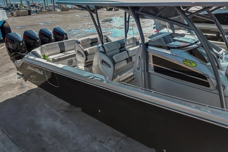 Slide: The Image of 2021 Nor-Tech 390 Sport Center Console boat with quad engines docked at marina. - 55
