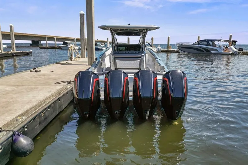 Slide: The Image of 2021 Nor-Tech 390 Sport Center Console with quad engines docked at marina. - 6