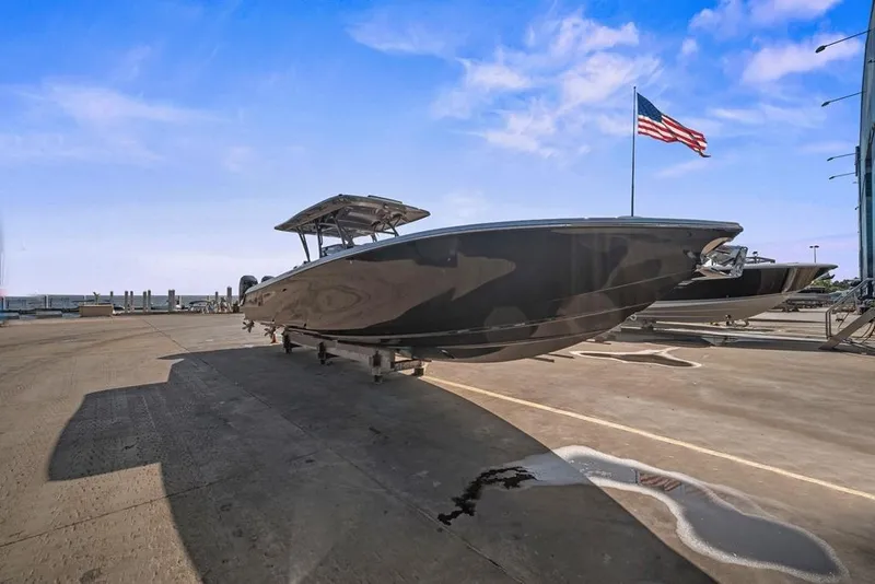 Slide: The Image of 2021 Nor-Tech 390 Sport Center Console boat on dock with American flag in background. - 7
