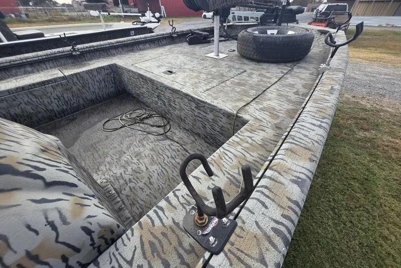 Slide: The Image of 2022 Xpress XP200 Catfish boat with camouflage design and fishing rod holders. - 12