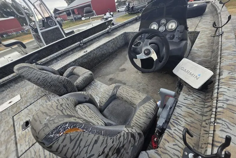 Slide: The Image of 2022 Xpress XP200 Catfish boat interior with Garmin navigation system and camo seating. - 14