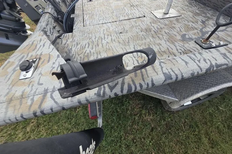 Slide: The Image of 2022 Xpress XP200 Catfish boat deck with camo pattern and fishing equipment. - 4