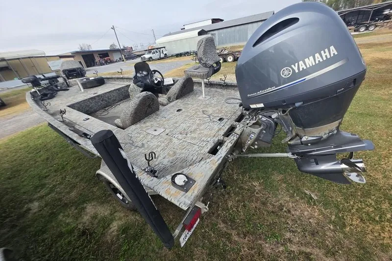 Slide: The Image of 2022 Xpress XP200 Catfish boat with Yamaha outboard motor, parked on grass. - 6