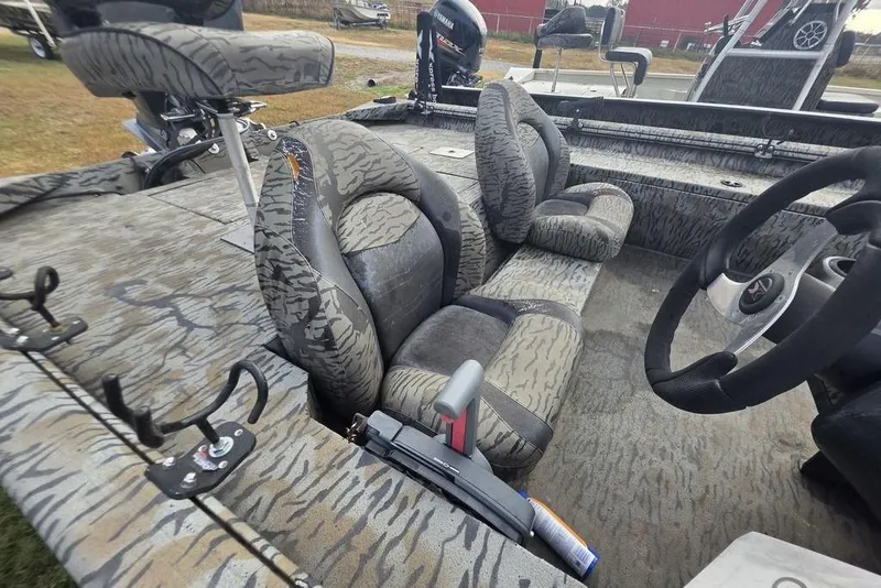 Slide: The Image of 2022 Xpress XP200 Catfish boat interior with camo seats and steering wheel. - 9