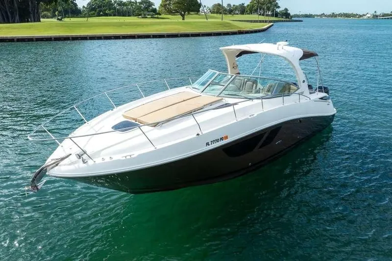Slide: The Image of 2010 Sea Ray 370 Sundancer yacht on calm water, showcasing sleek design and luxury features. - 10