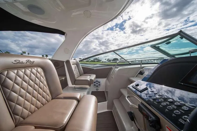 Slide: The Image of Luxurious interior of 2010 Sea Ray 370 Sundancer yacht with plush seating and modern controls. - 15