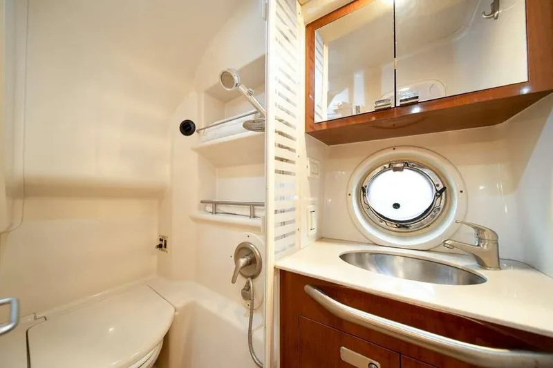Slide: The Image of Luxurious bathroom in 2010 Sea Ray 370 Sundancer yacht with porthole and modern fixtures. - 7