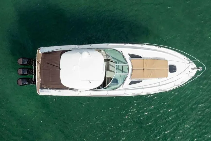Slide: The Image of Overhead view of 2010 Sea Ray 370 Sundancer yacht on green water. - 9