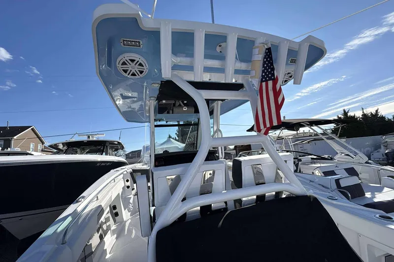Slide: The Image of 2024 Blackfin 302CC boat with American flag, sleek design, and modern features. - 10