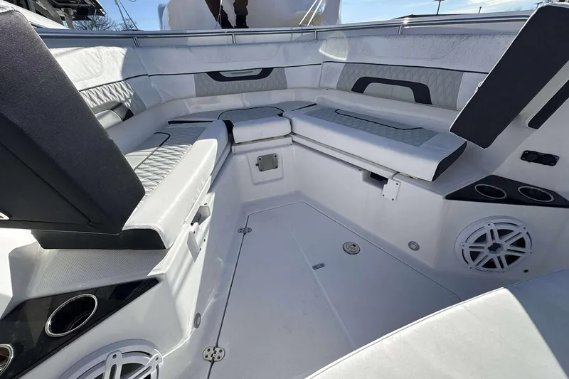 Slide: The Image of 2024 Blackfin 302CC boat interior with cushioned seating and built-in speakers. - 13