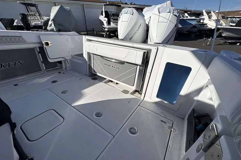Slide: The Image of 2024 Blackfin 302CC boat interior with storage compartments and Mercury engines. - 15