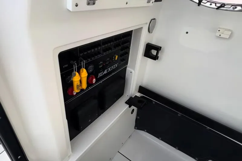 Slide: The Image of Control panel of 2024 Blackfin 302CC boat, featuring switches and safety equipment. - 18