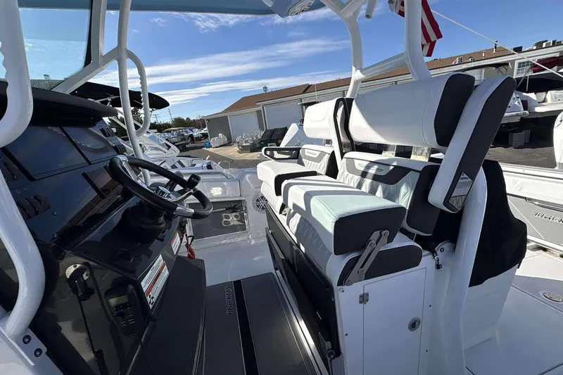 Slide: The Image of 2024 Blackfin 302CC boat interior with modern seating and steering console. - 8