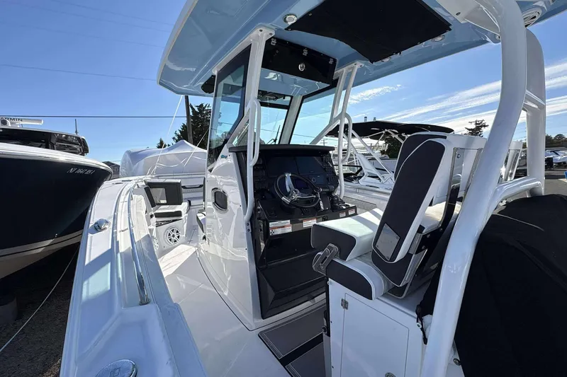 Slide: The Image of 2024 Blackfin 302CC boat interior with helm, seating, and modern navigation equipment. - 9