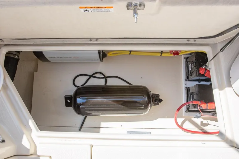Slide: The Image of 2026 Ranger Tugs R-31S storage compartment with equipment and wiring. - 13