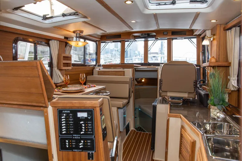 Slide: The Image of Luxurious interior of 2026 Ranger Tugs R-31S with elegant wood finishes and modern amenities. - 16