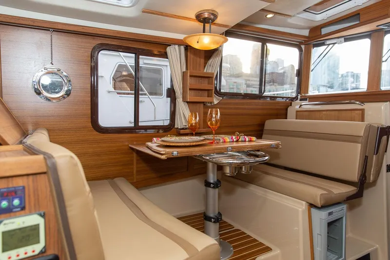 Slide: The Image of Luxurious interior of 2026 Ranger Tugs R-31S with elegant dining setup. - 17